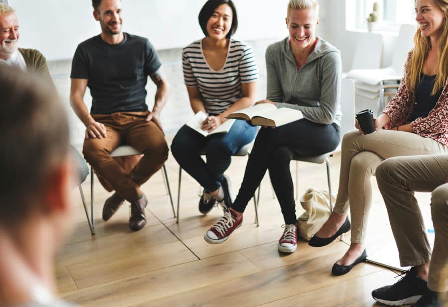 individuals laughing in therapy session