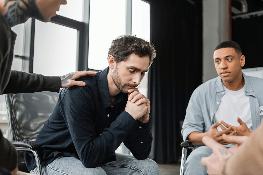 a man comforting a man in therapy
