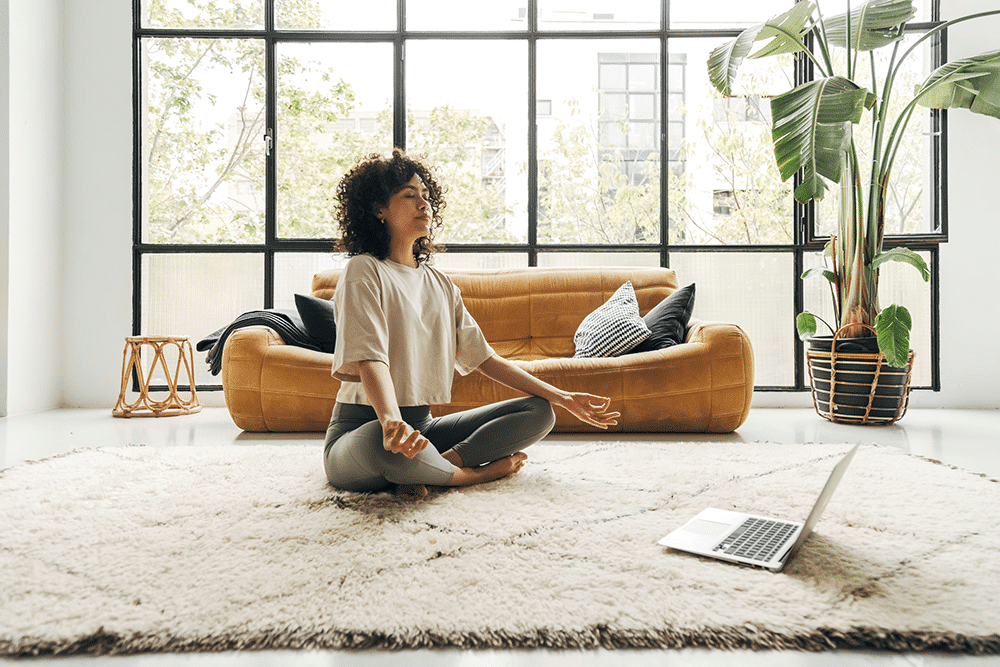 Girl practicing yoga and meditation at home as part of a holistic addiction treatment program in New Jersey