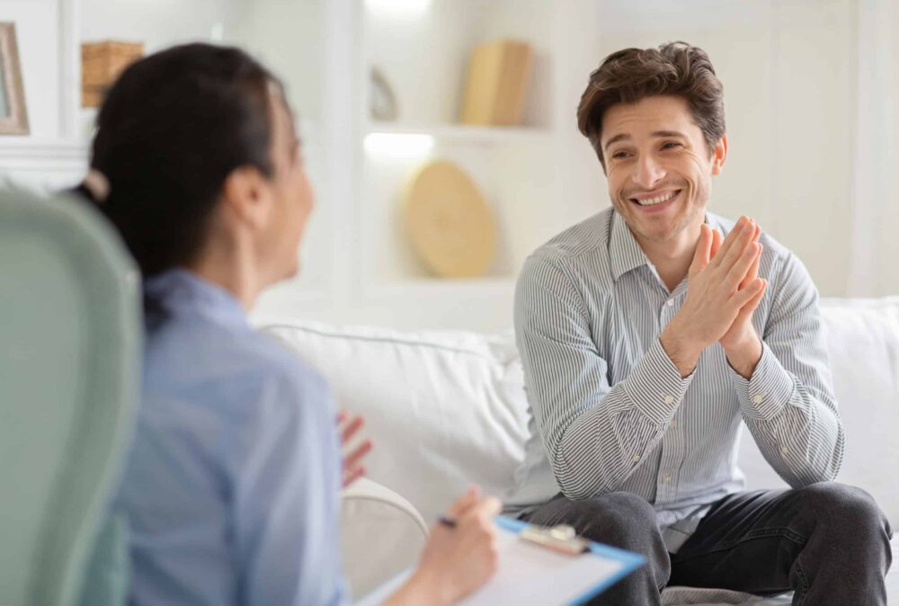 a man smiling during CBT for addiction treatment in New Jersey a man smiling during CBT for addiction treatment in New Jersey