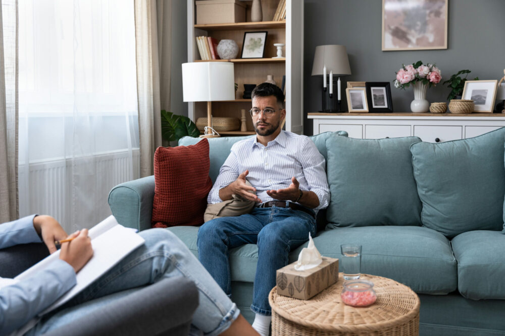 a-man-speaking-in-a-therapy-session