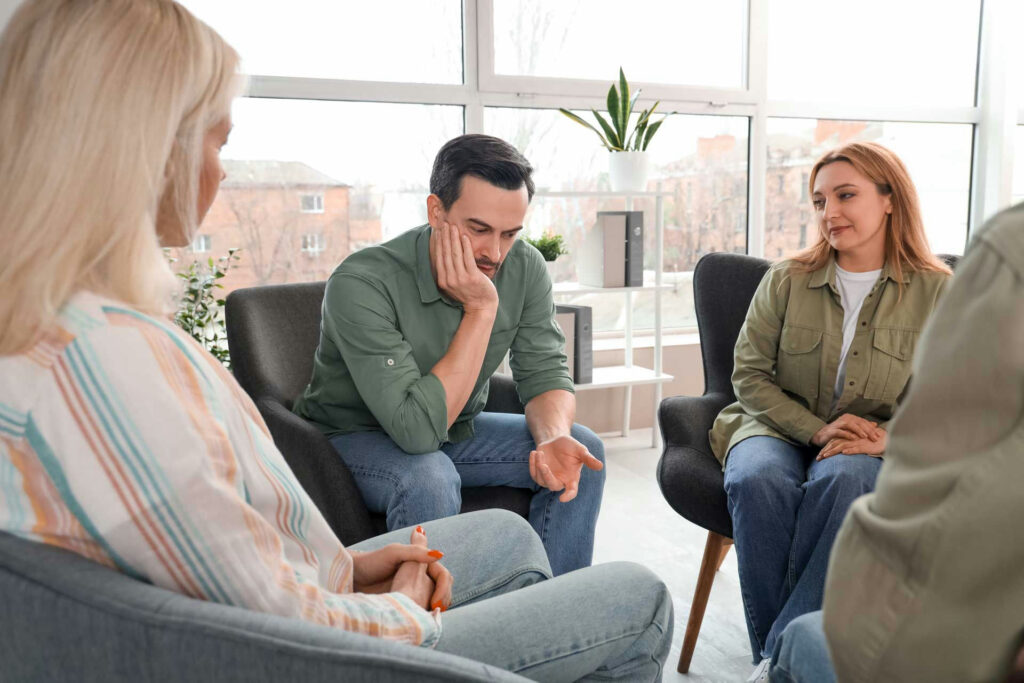 a-man-speaking-in-group-therapy